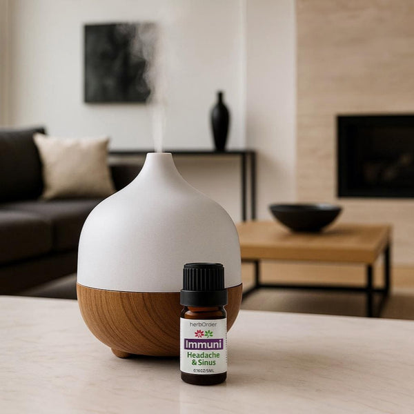 Infuser on table top with a small bottle of essential oil blend.